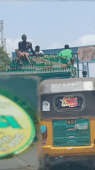 Overloaded beverage truck carries three passengers atop cargo in Nigeria
