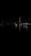 Eiffel Tower glowing at night over the Seine