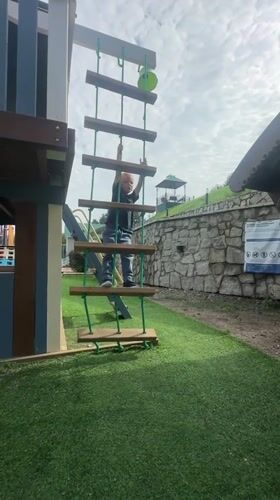 Playground afternoon in Danilovka, Altai, with wildflowers and slides