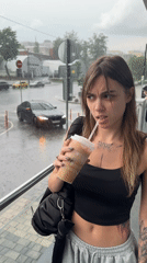 People shelter from heavy rain in Moscow