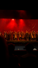 Moscow stage show: torches, smoke, and period costumes under red lights