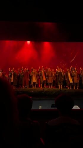 Moscow stage show: torches, smoke, and period costumes under red lights