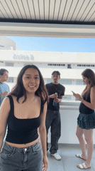 Four young adults gather on Aulas 2 balcony in Puebla