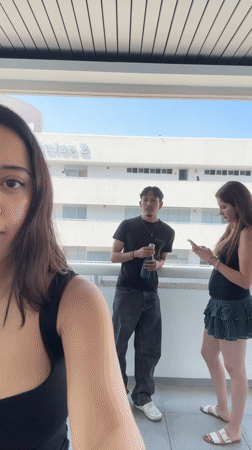 Four young adults gather on Aulas 2 balcony in Puebla