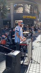 Street band performs in Argentina jerseys near Buenos Aires landmark