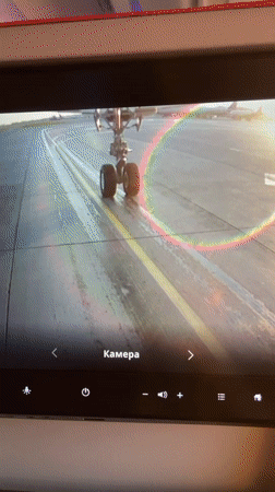 Passenger films landing gear camera feed during runway operations