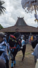 Decorated horses and ceremonial riders in a Grantung village procession