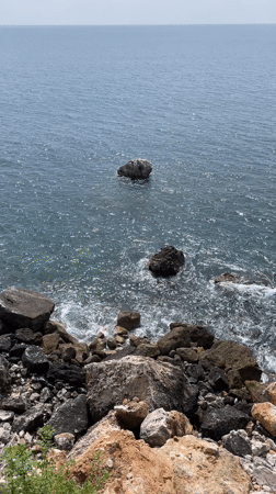 Person walks on historic stone wall in Sutomore