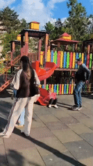 Children play at playground near Soviet-era jet monument in Tiraspol