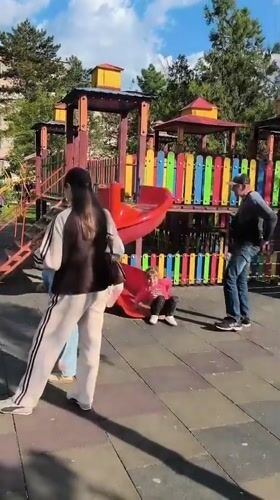 Children play at playground near Soviet-era jet monument in Tiraspol