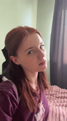 Woman in motivational shirt observed in bedroom setting