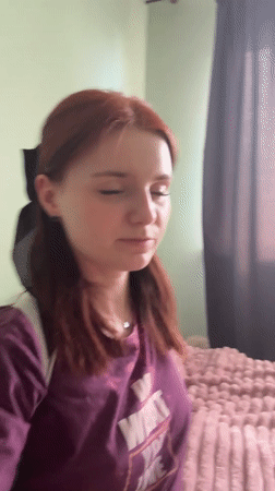 Woman in motivational shirt observed in bedroom setting