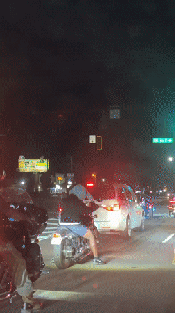 Motorcyclists gather at nighttime intersection in Surfside Beach