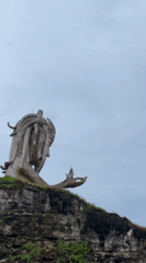 Weathered woman statue spotted on Nusa Penida coastal cliffs