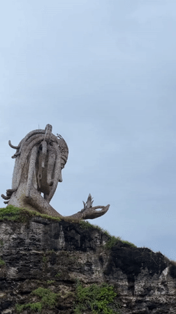 Weathered woman statue spotted on Nusa Penida coastal cliffs