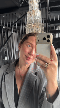 Woman takes selfies in formal attire at Russian locations