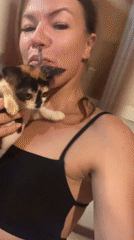 Woman holds calico kitten in North Kuta home
