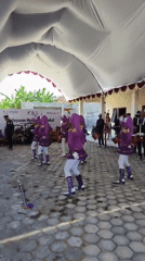 Marching band performs at sponsored outdoor event in Kalikondang