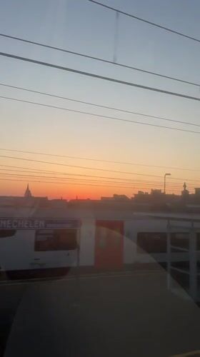 Sunset observed from moving train over Mechelen, Belgium