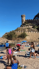 Tourists enjoy sunny afternoon at Tossa de Mar beach