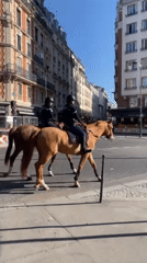 Mounted police patrol Paris streets on sunny afternoon