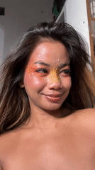 Woman poses with elaborate colorful makeup in North Jakarta