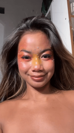 Woman poses with elaborate colorful makeup in North Jakarta
