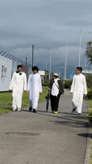 Four people walk paved path in traditional clothing, Sirius Russia
