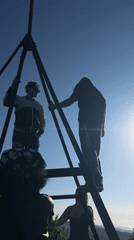 Visitors gather at Vladivostok hilltop observation tower overlooking mountains