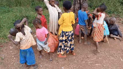 Children gather in outdoor clearing in Ngalula, DRC