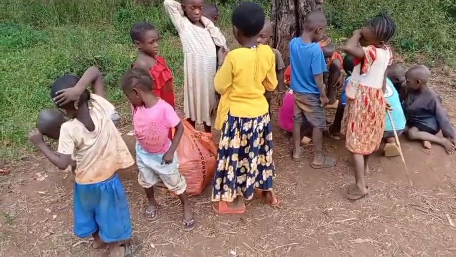 Children gather in outdoor clearing in Ngalula, DRC