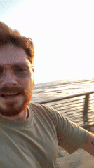 Man records message at Tel Aviv coast during golden hour