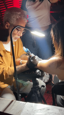 Swan-shaped faucet used under red lighting in NYC