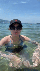 Resort beach bustling with activity on sunny May morning