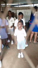 School kids in uniform gather and move around a Nigerian schoolyard