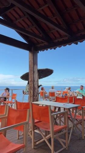 Leisurely morning at oceanfront restaurant and promenade in Funchal