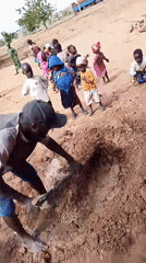 Man digs soil, poses for photos in Nigerian village