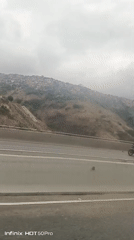 Highway traffic recorded near Caracas shantytown