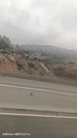 Highway traffic recorded near Caracas shantytown