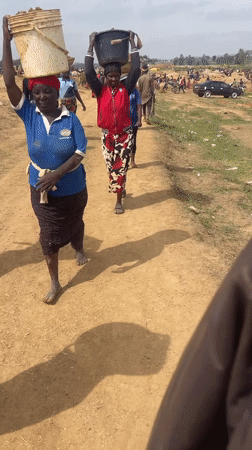 Rural residents carry soil buckets in Maiyanga, Nigeria