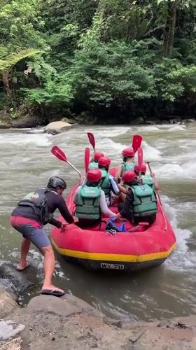 Tourist rafting group navigates whitewater rapids in Payangan, Indonesia