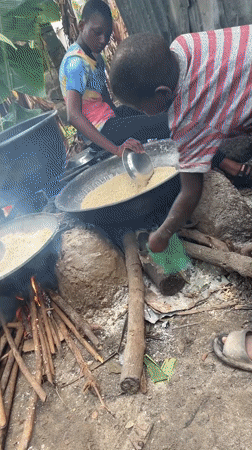 Open-fire cooking with large pots in Badagry, Nigeria