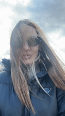 Woman takes windy selfie in Prada jacket, Latvia