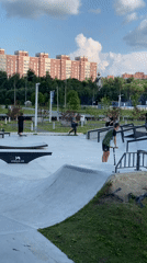 Scooters and skateboards at a Russian skatepark on a sunny day