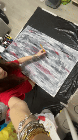 Artist paints abstract canvas, woman takes selfies in Raanana