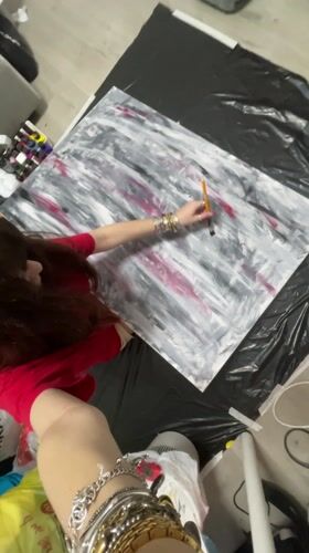 Artist paints abstract canvas, woman takes selfies in Raanana
