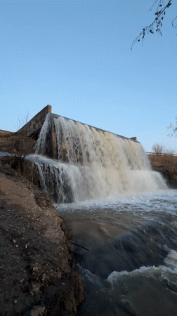 Russian dam waterfall documented during evening hours near Kamennoye
