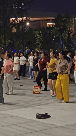 Synchronized nighttime dancing in a Qiantang District plaza