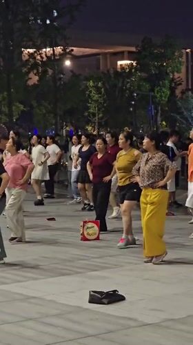 Synchronized nighttime dancing in a Qiantang District plaza