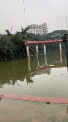 Toy vendor blows bubbles at a waterlogged Ramna Park